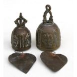 A pair of Tibetan bronze roof bells with Buddhist motifs and attached wind chimes, the largest 10cms