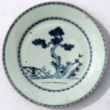 A Chinese blue & white charger decorated with a tree beside a bridge, 32cms (12.5ins) diameter (a/