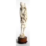 A late 19th / early 20th century Chinese carved ivory figure of a fisherman holding his catch, 28cms