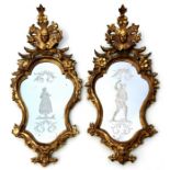 A pair of late 18th century Italian reverse cut giltwood wall mirrors, 46 by 96cm (18 by 37.75ins)