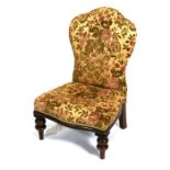 A Victorian upholstered nursing chair on turned front supports.