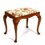 An early 20th century beech rectangular stool with drop-in upholstered seat on cabriole legs.