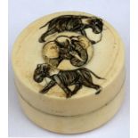 A late 19th century Japanese Meiji period ivory lidded box decorated with elephants, 7cms (2.