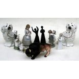 A pair of Staffordshire dogs; together with a group of Nao figures; a pair of Royal Doulton figures;