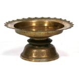 A large Indian brass bowl or dish on stand decorated with animals and birds, 49cms (19.25ins)