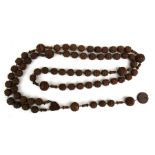 A large late 19th century French carved fruit nut rosary.