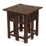 An Indian carved hardwood square topped occasional table on folding base, 53cms (21ins) wide.