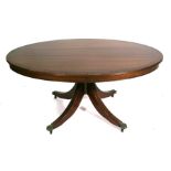 A reproduction mahogany oval coffee table on quatrefoil legs with lion paw feet, 117cms 46ins)