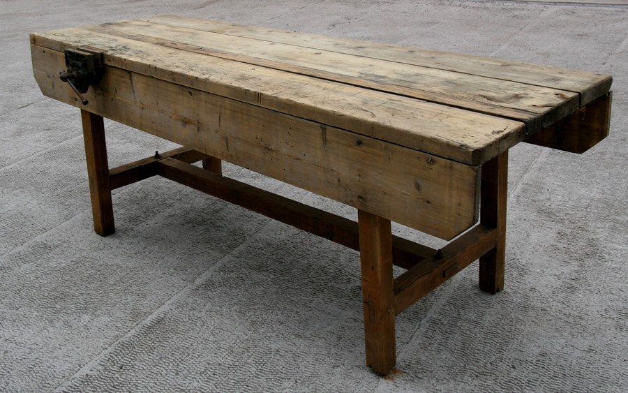 A large pine carpenter's workbench with Record No. 52 wood vice attached, 229cms (90ins) long.