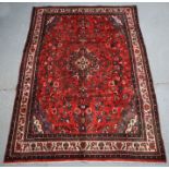 A Persian Hamadan woollen hand knotted rug with foliate design on a red & cream ground, 280 by