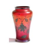 A Tiffany style Art glass vase decorated with holly leaves on a red iridescent ground, 10cms (