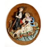 A Victorian figural bisque wall plaque depicting a young couple, 25cms (9.75ins) high.