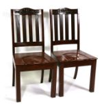 A pair of mahogany hall chairs with carved crest rail and reeded back splats.