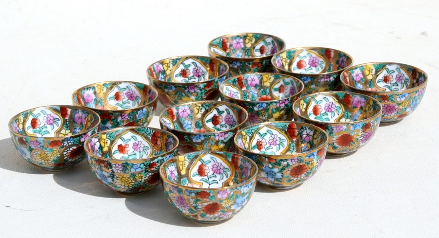 A set of twelve Chinese millefiori wine cups each depicting signs of the Chinese zodiac, 5cms (2ins)
