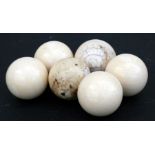 Two ivory snooker or billiard balls, 5cms (2ins) diameter; together with four simulated ivory