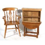 A beech kitchen carver chair; together with a stripped pine set of wall shelves and an oak swivel
