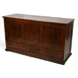An 18th / 19th century large oak mule chest, the hinged top enclosing a candle tray and three