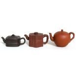 A group of three Chinese Yixing pottery teapots, the largest 18cms (7.2ins) wide.Condition Report
