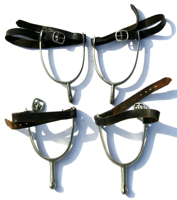 Two pairs of 20th century cavalry spurs with straps