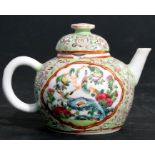 A Chinese miniature Canton famille rose teapot decorated with birds on a green ground, 7cms (2.