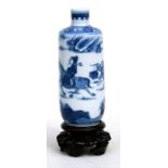 A Chinese blue & white snuff bottle decorated with a robed figure on horseback with a servant