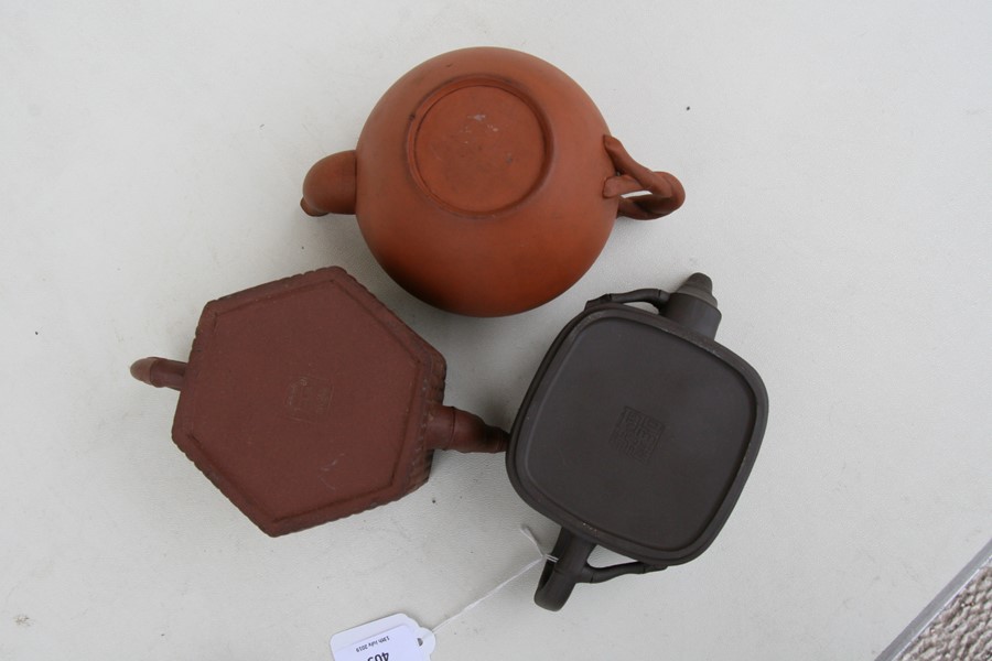 A group of three Chinese Yixing pottery teapots, the largest 18cms (7.2ins) wide.Condition Report - Image 3 of 11