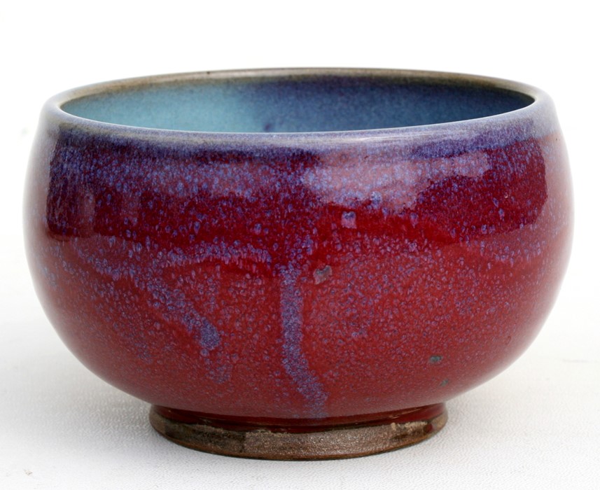 A Chinese Jun ware bowl with mottled red and blue glaze, 14cms (5.5ins) diameter.