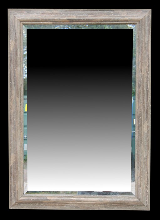 A modern bevel edged rectangular wall mirror, 76 by 106cms (30 by 41.5ins).