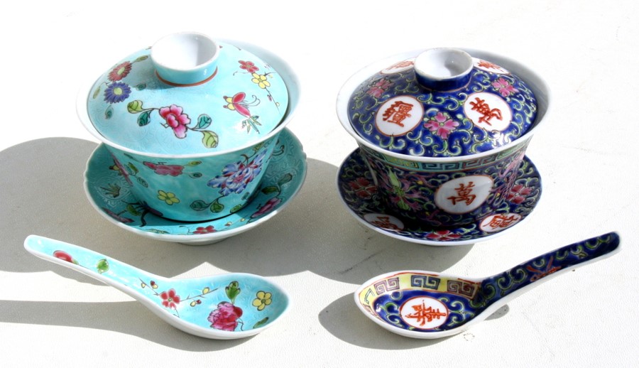 A Chinese famille rose rice bowl, cover, stand and spoon decorated with flowers and butterflies on a