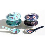 A Chinese famille rose rice bowl, cover, stand and spoon decorated with flowers and butterflies on a