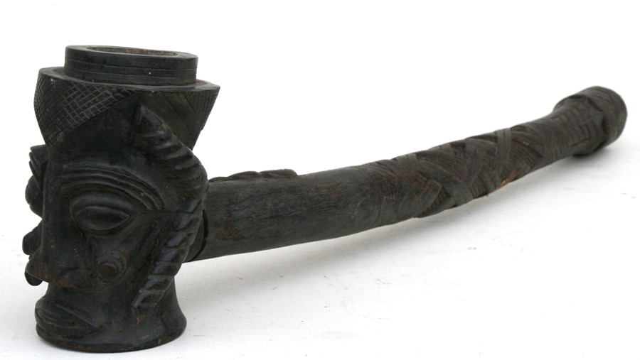 A large African carved wooden pipe, the bowl in the form of a stylised head, 60cms (23.5ins) long. - Image 2 of 2