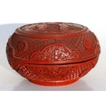 A Chinese cinnabar lacquer box & cover of compressed globular form, decorated with flowers and