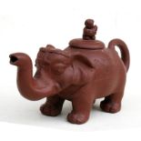 A Chinese Yixing pottery teapot in the form of an elephant with figural finial, 11.5cms (4.5ins)