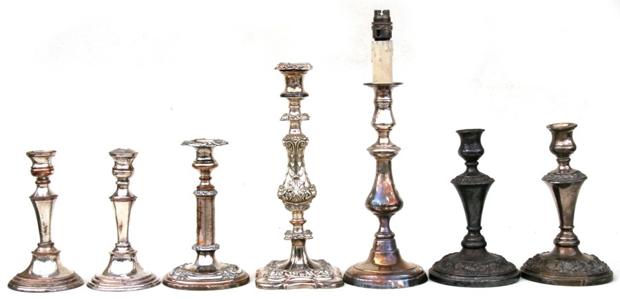 Two pairs of silver plated candlesticks; together with three single silver plated candlesticks.