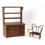 A pine miniature dresser, the plate rack above three long drawers with a cupboard beside, 27cms (