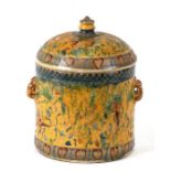 A Persian / Middle Eastern pottery jar and cover decorated with foliate scrolls on a yellow