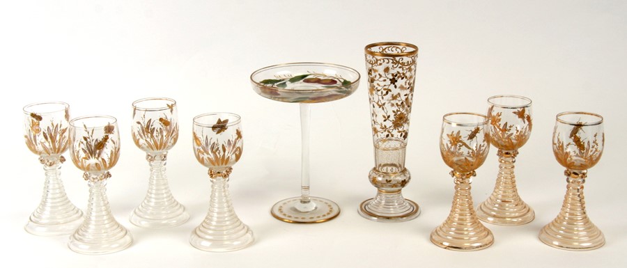 Seven gilded wine glasses decorated with insects, 16cms (6.25ins) high; together with a matching