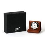 A leather cased Mont Blanc travel alarm clock, the white circular dial with Arabic numerals and