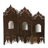 An Indian pierced and carved hardwood triptych graduated picture frame or shrine, 75cms (29.5ins)