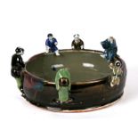 A Japanese bowl with applied figures to the rim, 27cms (10.5ins) diameter.Condition Report Loss of