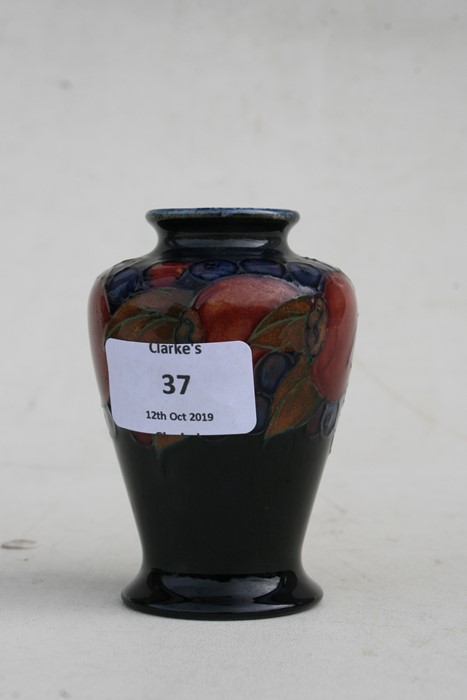 A Moorcroft vase decorated with fruit, 9cms (3.5ins) high.Condition Report Crazing to glaze, - Image 5 of 7