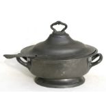 An 18th century oval two-handled pewter tureen and ladle, 36cms (14ins) wide.