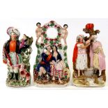 Three 19th century Staffordshire Pottery groups, the largest 35cms (13.75ins) high (3).