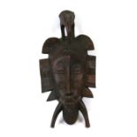 An African carved hardwood mask, 43cms (17ins) high.