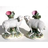 A pair of 19th century Staffordshire Pottery spill vases in the form of sheep, 19cms (7.5ins) high.