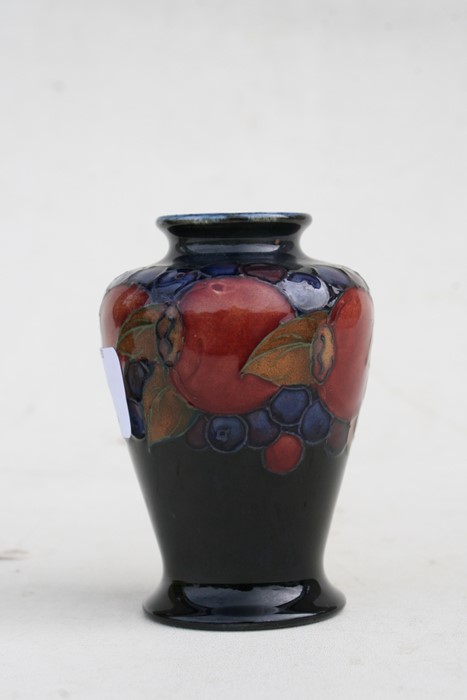 A Moorcroft vase decorated with fruit, 9cms (3.5ins) high.Condition Report Crazing to glaze, - Image 6 of 7