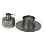A 19th century pewter Capstan inkwell, 19cms (7.5ins) diameter; together with a Norwegian pewter jug
