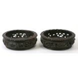 A pair of pieced and carved hardwood wine coasters in the Chinese style. 17cm (6.75 ins)