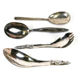 A group of four large Eastern white metal spoons.