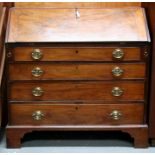 A Georgian mahogany bureau, the fall flap enclosing a fitted interior with drawers and pigeon